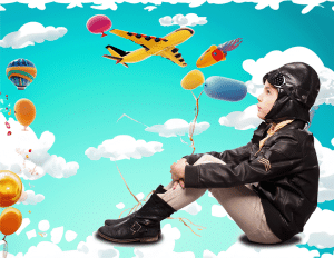 Niño vestido de piloto aviador; como fondo un cielo azul por el que cruzan aviones, globos aerostáticos, nubes y globos.